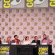the cast and crew of severance on stage at comic con